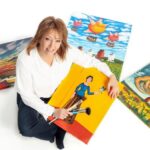 Pam on floor surrounded by artwork cropleft FINISHED Jan 25'23 THUMBNAIL